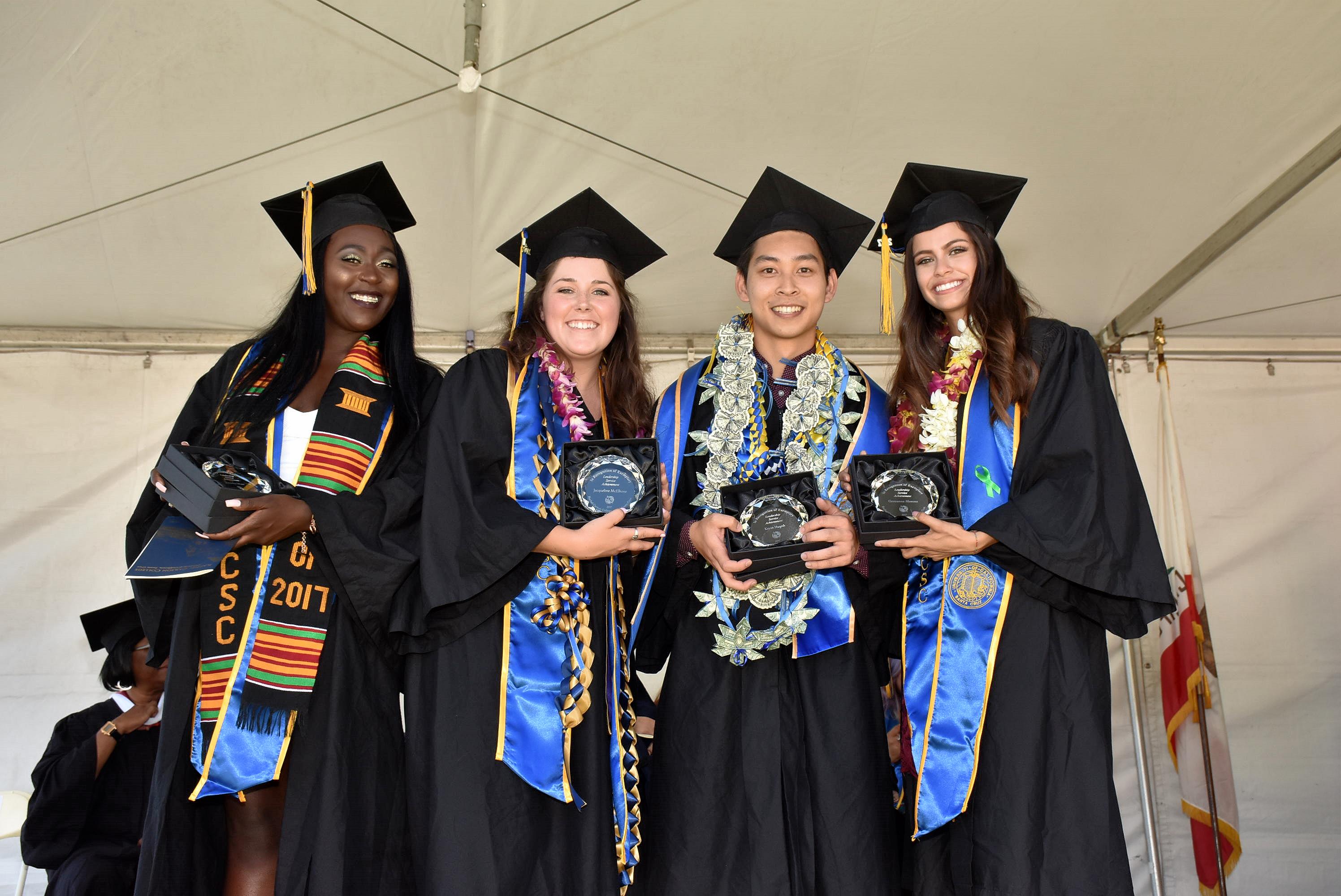 graduating students pose with senior recognition trophies